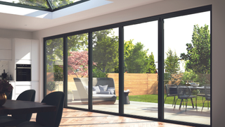 A modern home interior with aluminium bi-fold doors leading out to a garden