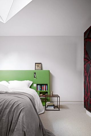 a green headboard with built in storage