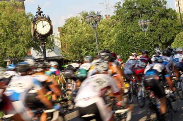Riders pass by an Augusta landmark clock