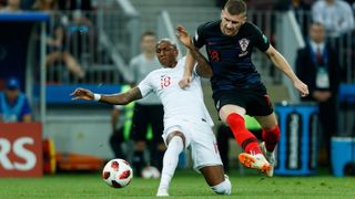 Ashley Young of England and Ante Rebic of Croatia battle for the ball during the 2018 FIFA World Cup Russia semifinal match between Croatia and England at Luzhniki Stadium on July 11 in Moscow.