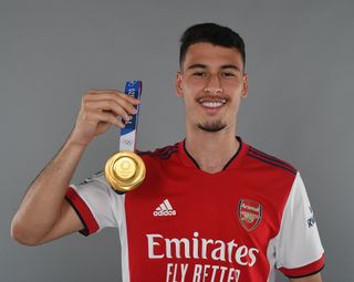 Arsenal forward Gabriel Martinelli shows off the gold medal he won with Brazil at the 2020 Olympics.