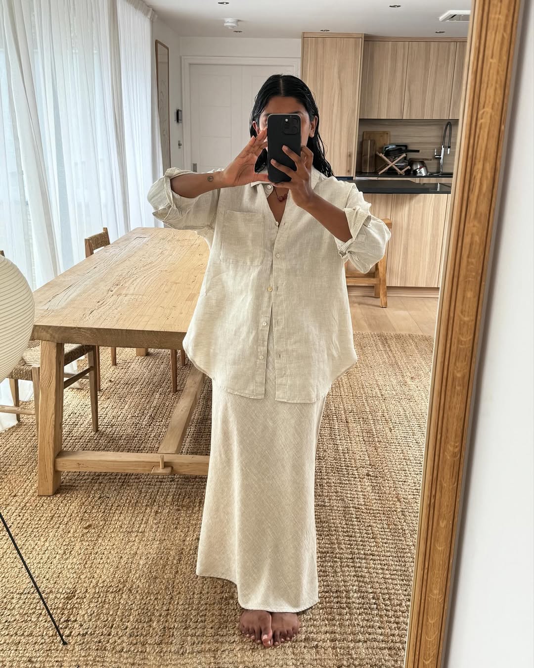 @monikh wears a beige linen skirt with a matching button-up shirt