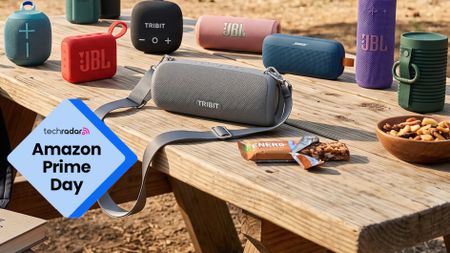 A selection of Bluetooth speakers, on a picnic table