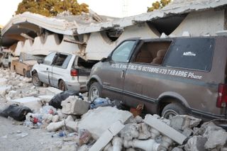 Vehicles crushed beneath the second-story balcony of the Hotel D'Haiti, in Port-au-Prince, Haiti. The hotel was destroyed in the 2010 earthquake.