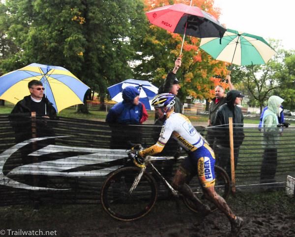 Bart Wellens (Telenet Fidea Cycling) racing past countless umbrellas