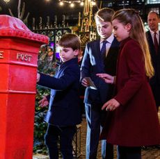 Prince George, Prince Louis and Princess Charlotte putting letters in a mailbox