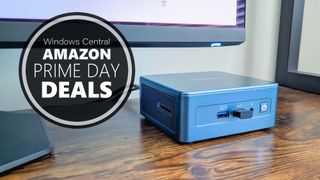 Geekom IT13 mini PC on a desk below a monitor. A graphic reads "Windows Central Amazon Prime Day Deals."