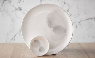 Two white plates with soft grey motif