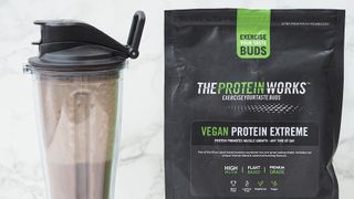 The Protein Works Vegan Protein Extreme bag and shaker on a table
