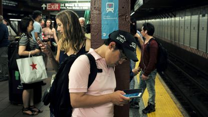 New Yorkers checking their phone's on the subway