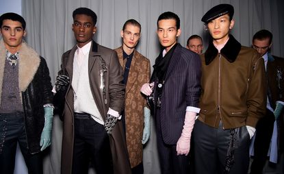 Five male models wearing clothing by Dior in shades of brown.