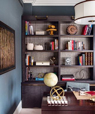 Traditional home office with vintage furniture and blue walls