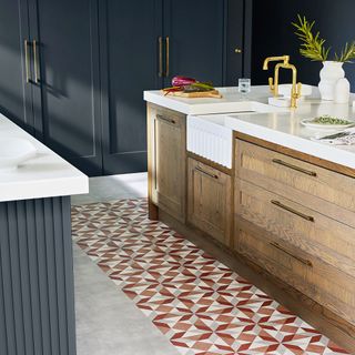 Luxury vinyl floor tiles in a blue kitchen