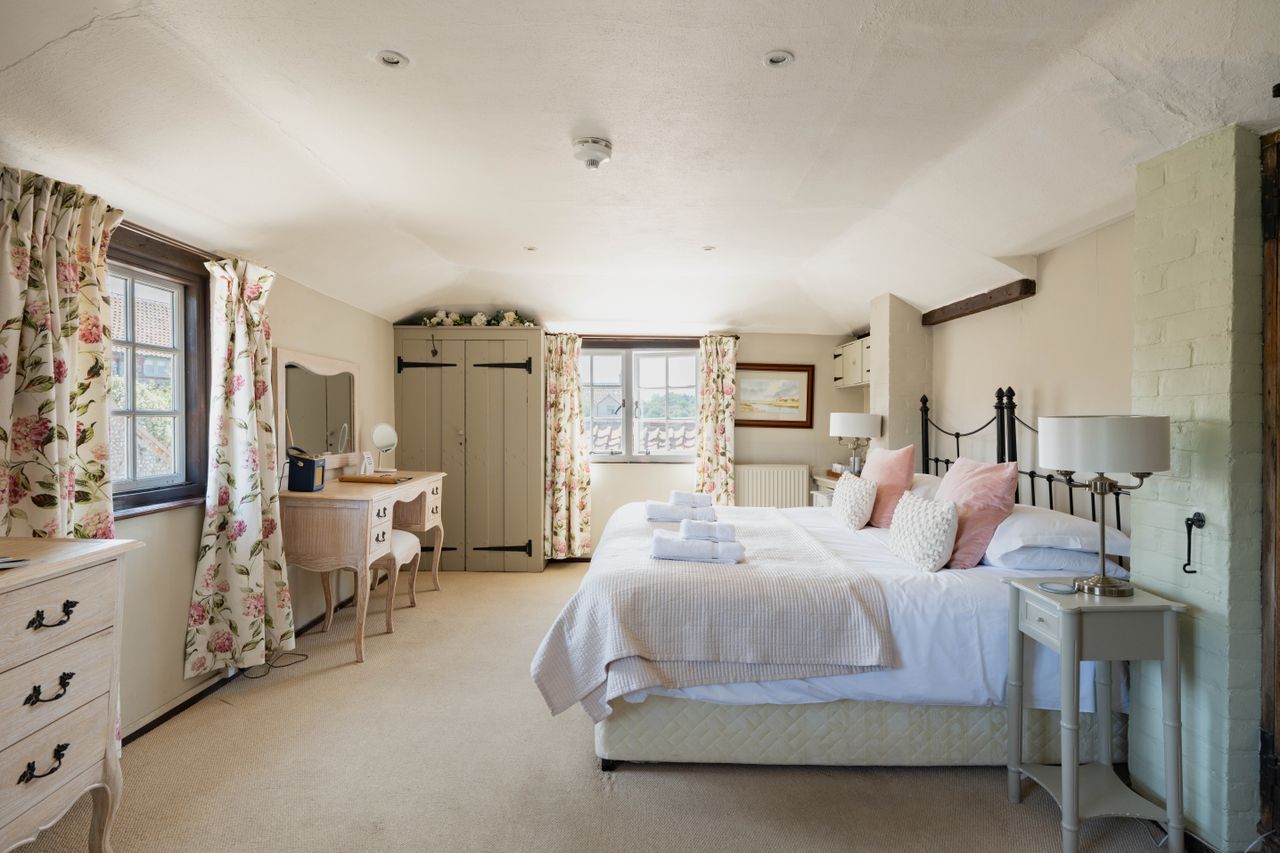 Cley Windmill. The mill is surrounded by reed beds and little rivers, and it is red brick with a white top. Inside, the rooms are luxurious but rustic, with lots of brick and exposed beams.