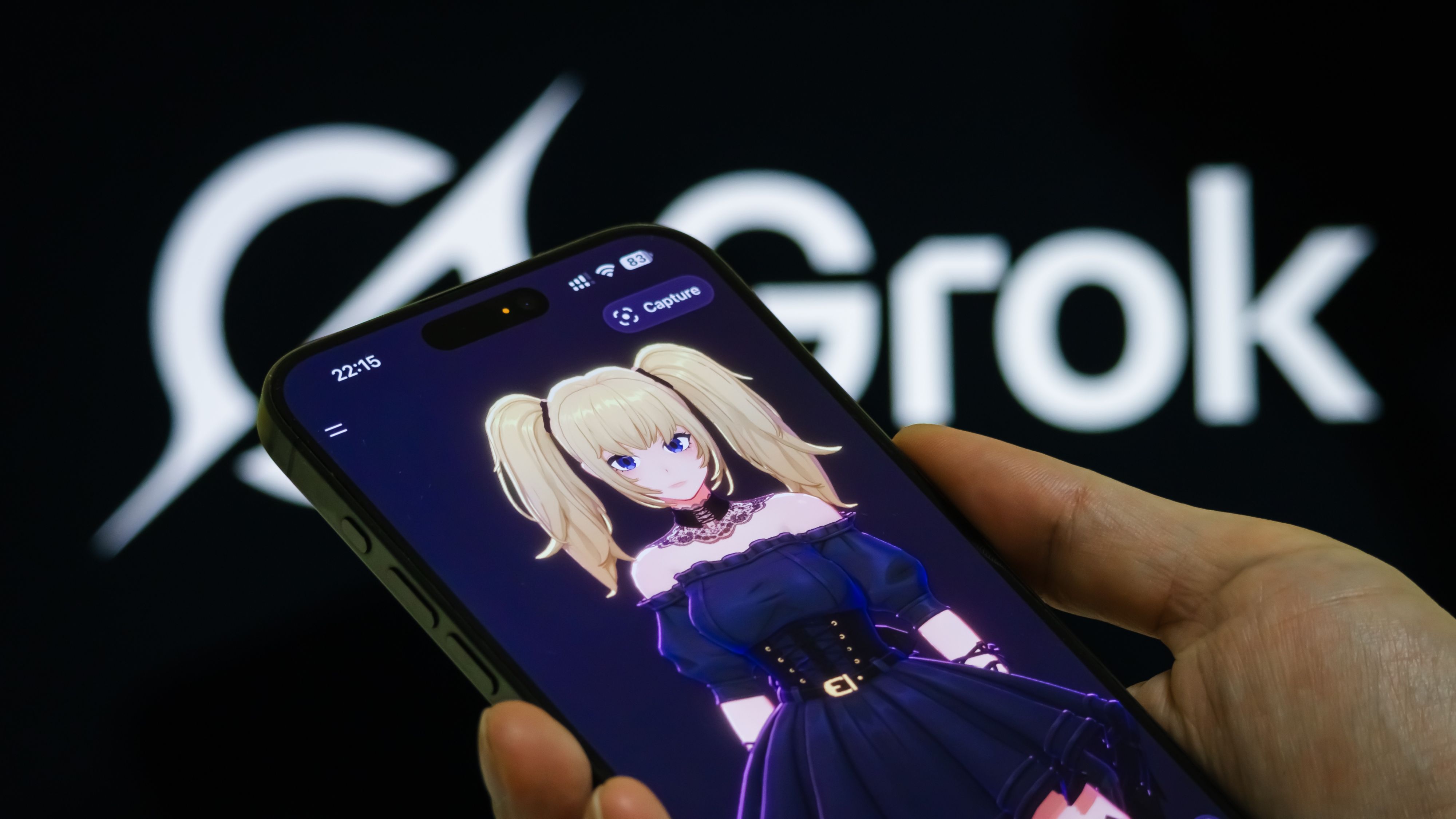 A person holds a smartphone showing Ani, a virtual anime-style assistant character featured in the Grok 4 AI chatbot developed by xAI, with the Grok logo visible on a screen in the background.