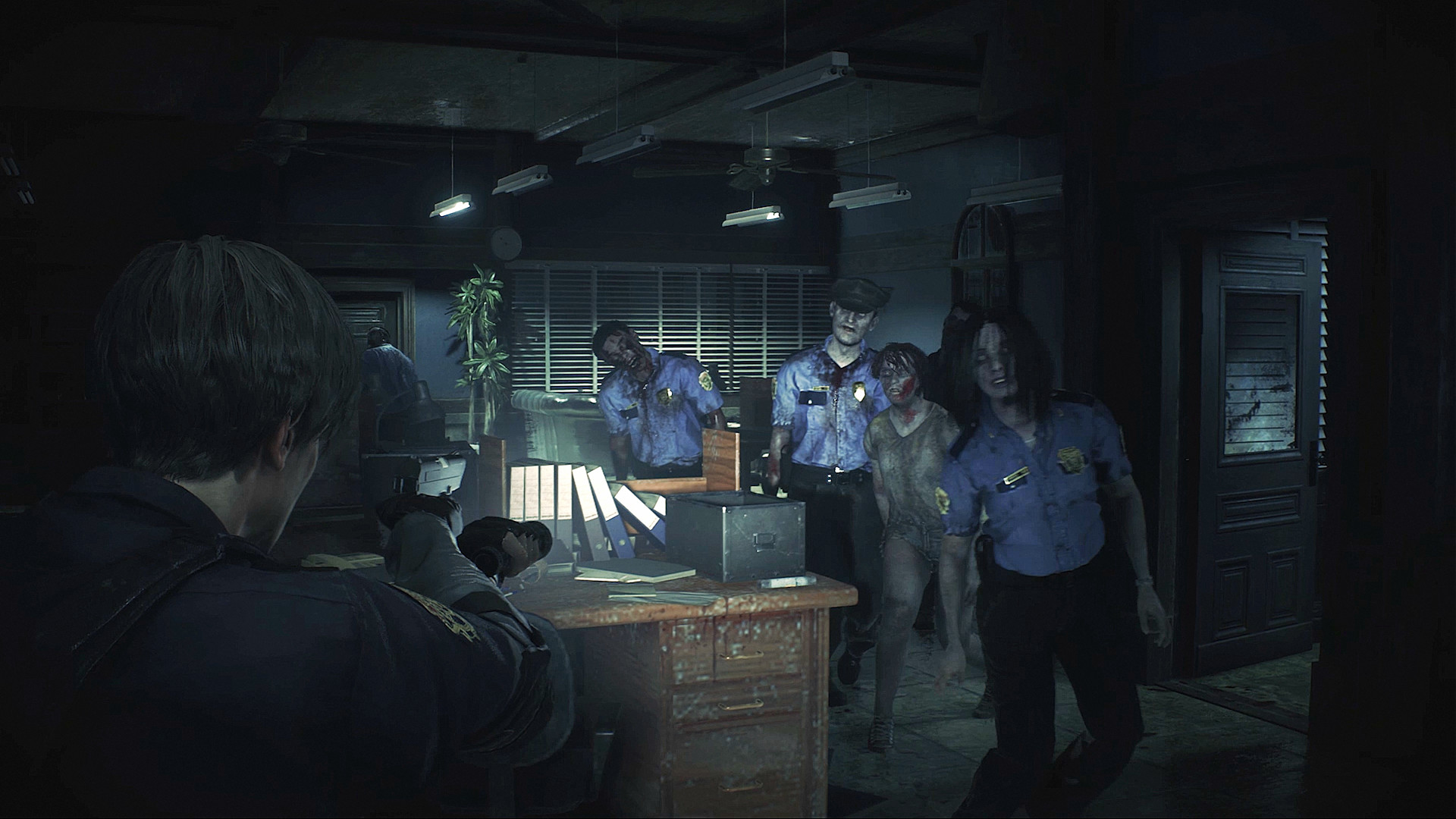 Leon pointing a pun at a bunch of police zombies during the Resident Evil 2 remake