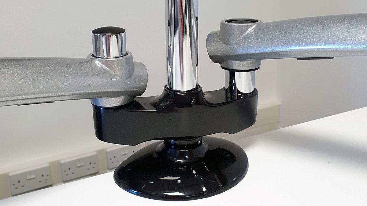 The extra divider part fits on to the same desk grip as the single Freedom Arm and works simply to provide another base for the second monitor.