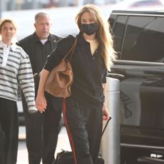 An image of Jennifer Lawrence wearing a polo with Adidas tracksuit and water shoes. 