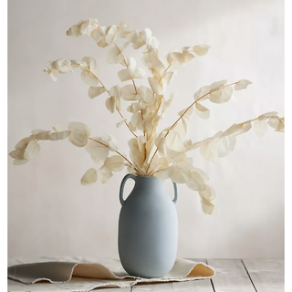 white eucalyptus bunch in a blue vase