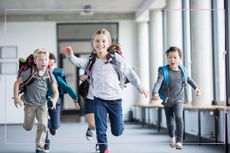 Children in rucksacks running down a corridor