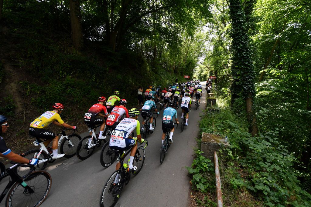 DURBUY BELGIUM JUNE 18 Kevin Vauquelin of France and Team Arka Samsic yellow best young jersey Clement Russo of France and Team Arka Samsic Arnaud De Lie of Belgium and Team Lotto Soudal Taco Van Der Hoorn of Netherlands and Team Intermarch Wanty Gobert Matriaux and a general view of the peloton passing through a wooded area during the 91st Baloise Belgium Tour 2022 Stage 4 a 1722km stage from Durbuy to Durbuy BaloiseBelgiumTour on June 18 2022 in Durbuy Belgium Photo by Luc ClaessenGetty Images