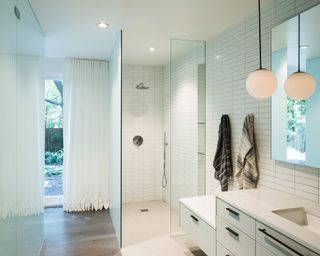 Basement bathroom with shower and vanity with white tile