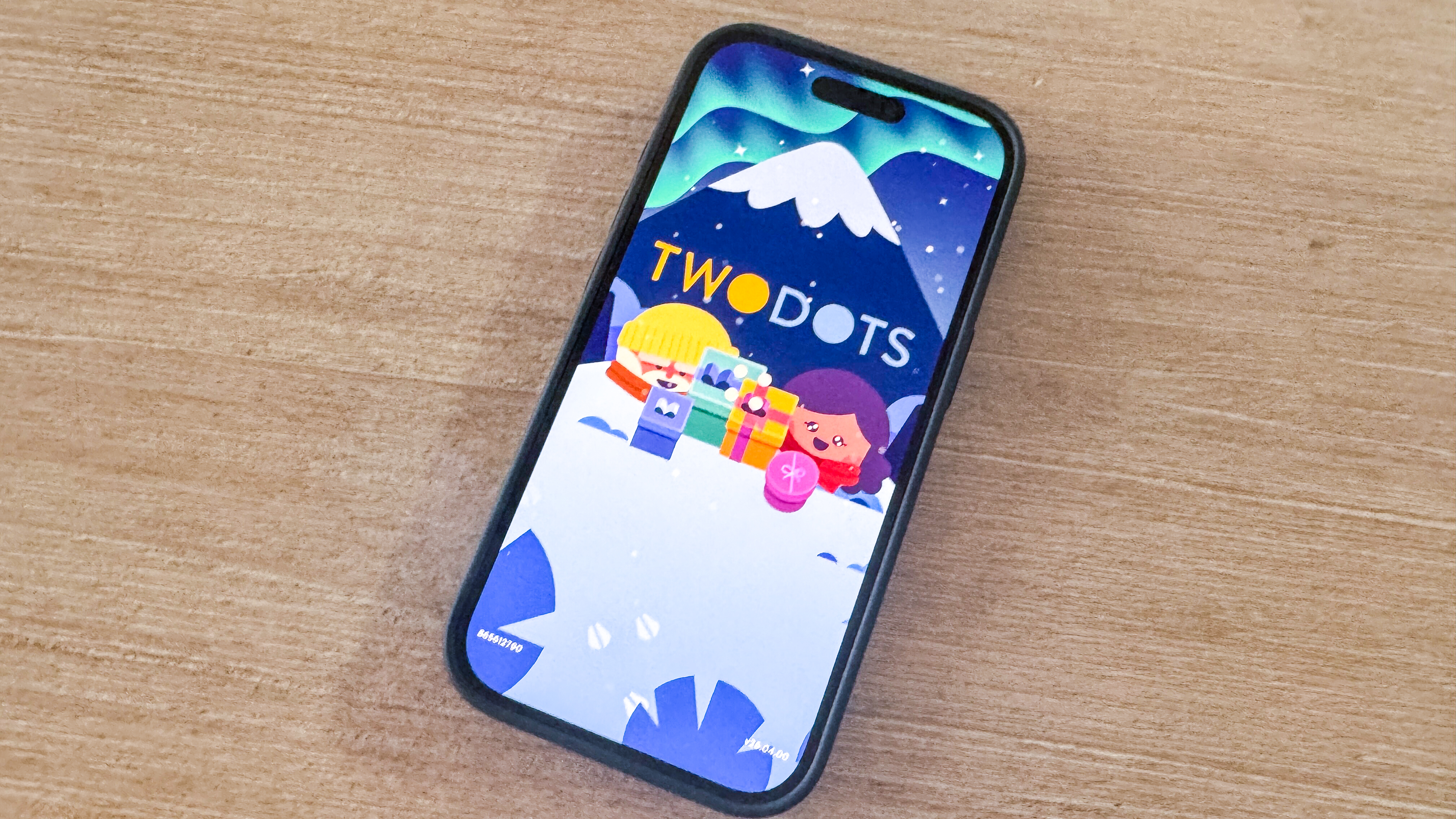Two Dots mobile game loading on an iPhone 17 Pro