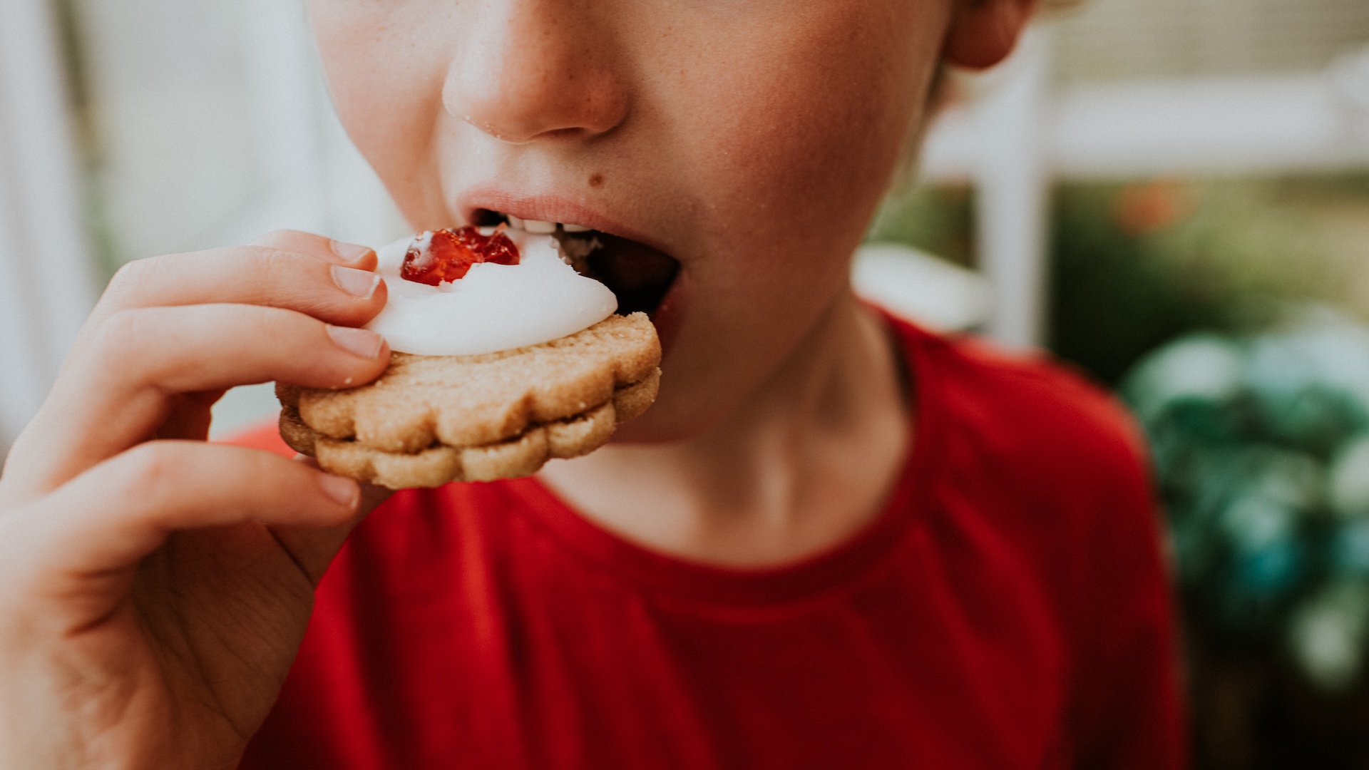 a close-up of a child eating a cookie