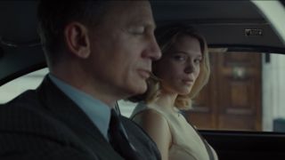 Daniel Craig and Léa Seydoux, sitting happily in the Aston Martin, in Spectre.