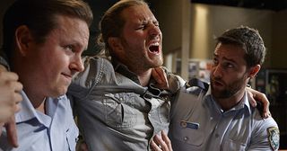 Ben Murray and another policeman take Martin 'Ash' Ashford to hospital thinking he is concussed in Home and Away.