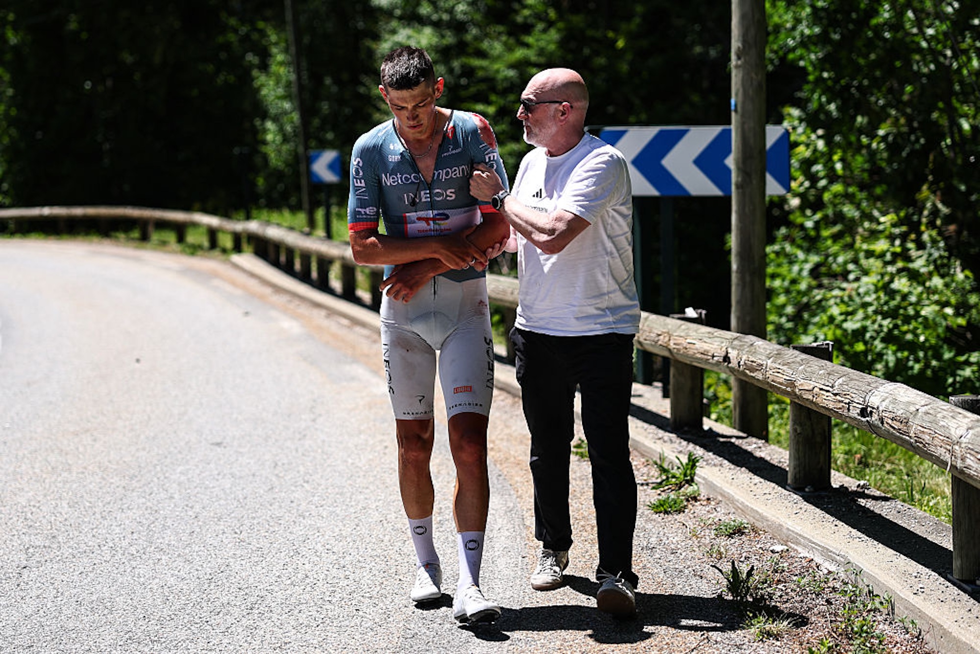 Netcompany Ineos Cycling Team's British rider Joshua Tarling receives attention after suffering a crash during the 6th stage of the Tour Auvergne-Rhone-Alpes cycling race