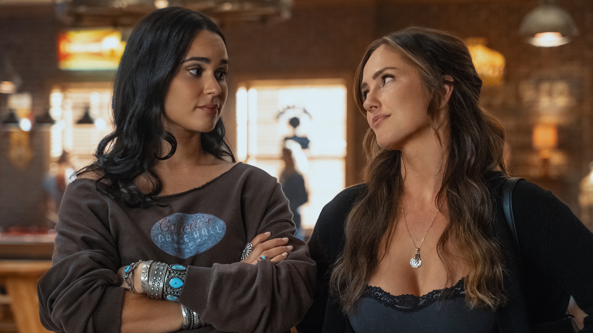 RANSOM CANYON SEASON 2. (L to R) Marianly Tejada as Ellie and Minka Kelly as Quinn in Episode 201 of Ransom Canyon Season 2. Cr. Jeff Neumann/Netflix &amp;copy; 2025