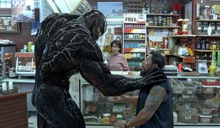 Venom choking a robber in a convenience store