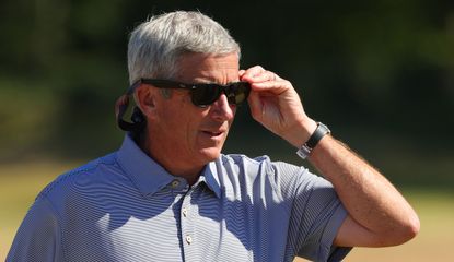 Monahan puts on his sunglasses as he walks down the fairway