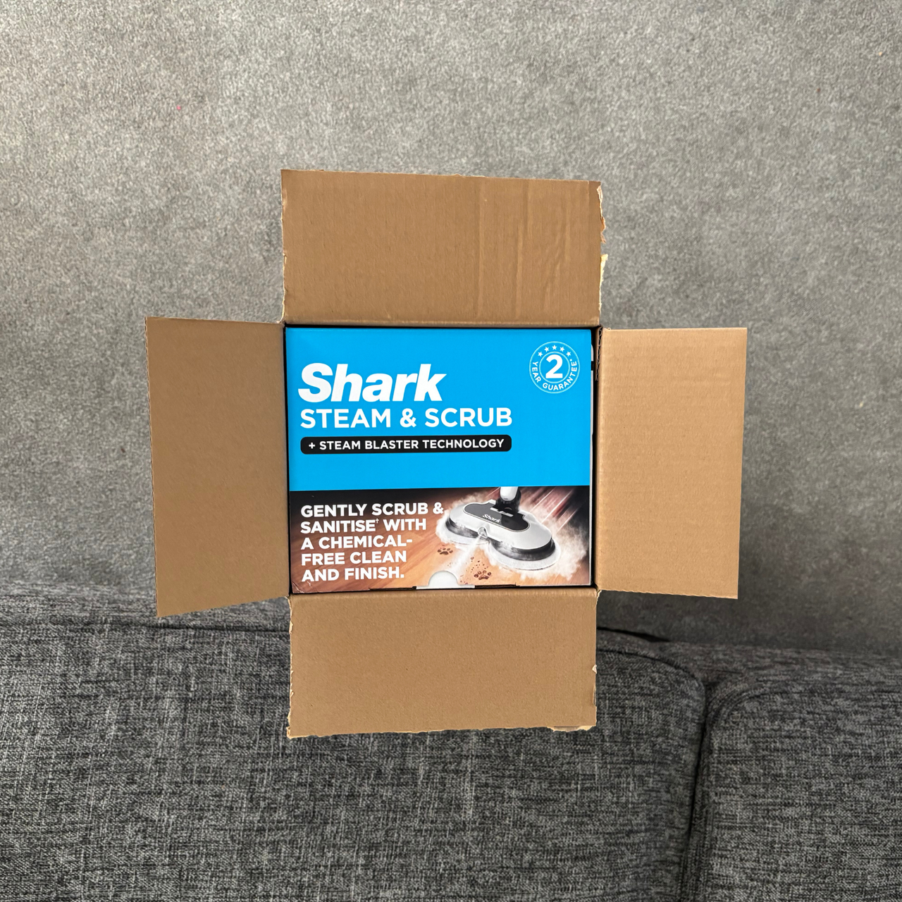 Top-down view of the Shark Steam &amp; Scrub outer packaging with branded second layer inside