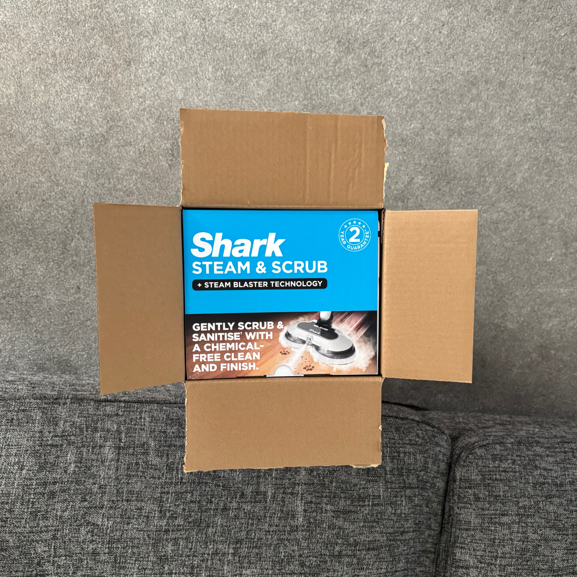 Top-down view of the Shark Steam & Scrub outer packaging with branded second layer inside