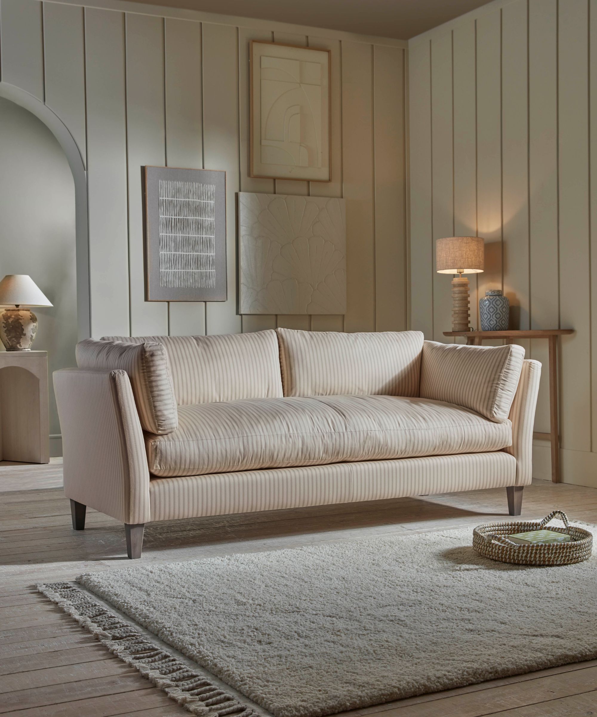A simple pale gold striped sofa