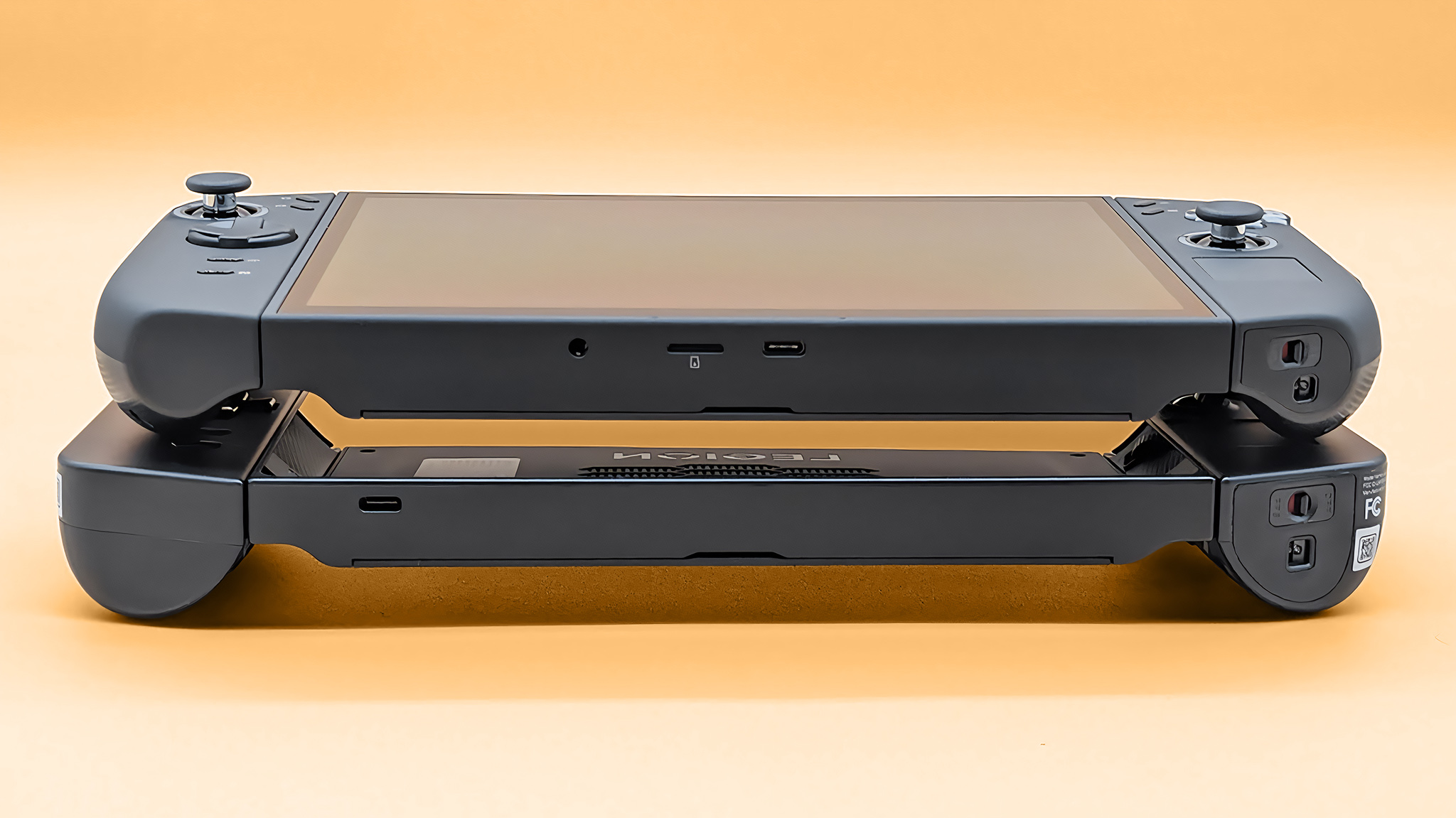 The Lenovo Legion Go 2 on the original Legion Go. The camera is angled so you can view the bottom of these devices.