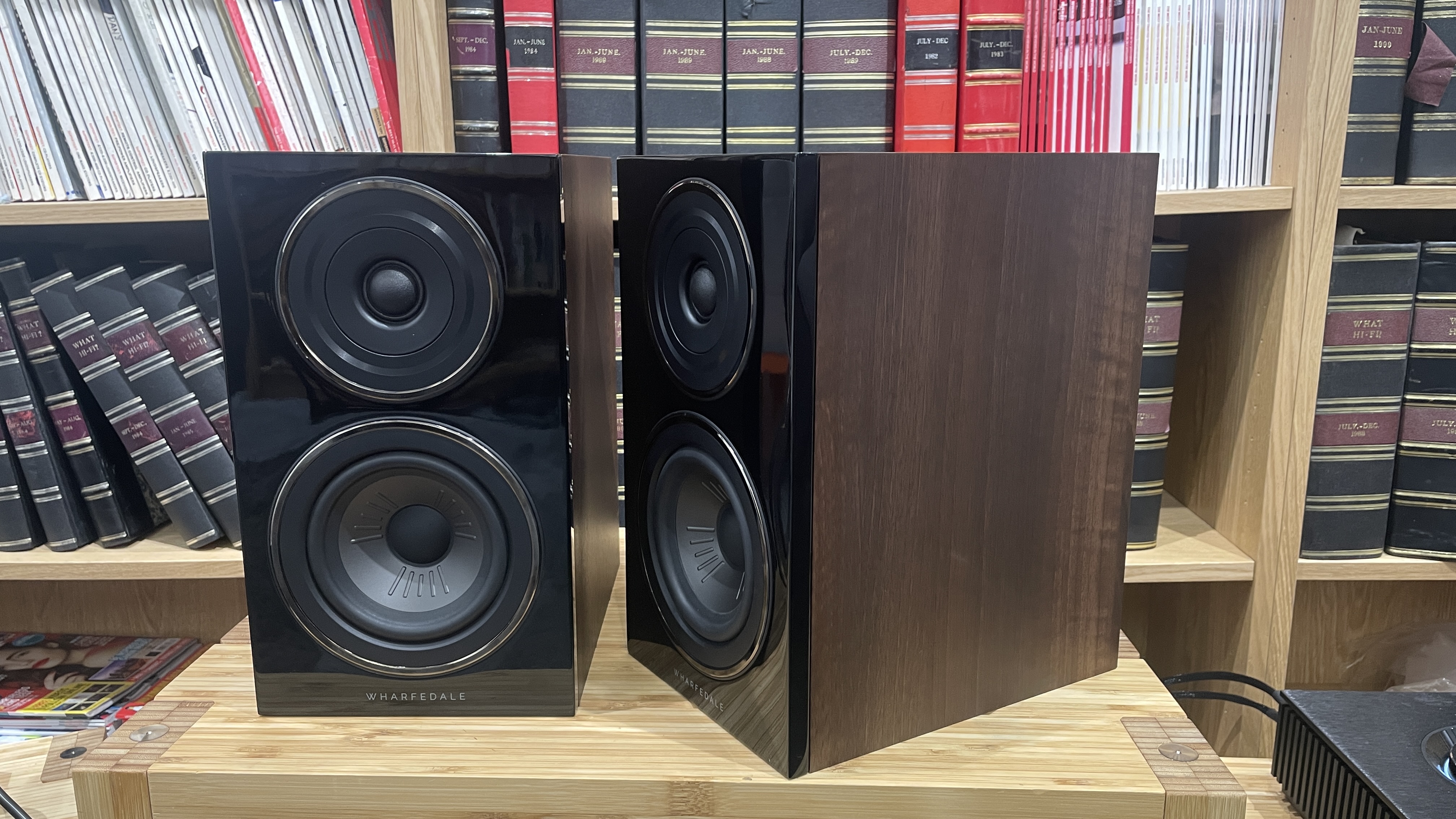 Wharfedale Diamond 12.1 stereo speakers in walnut veneer finish on a wooden rack