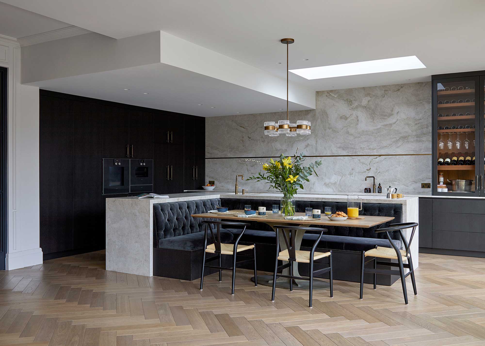 modern kitchen with full height units and central island with upholstered banquette seating