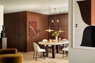 a dining space with a hidden door in millwork