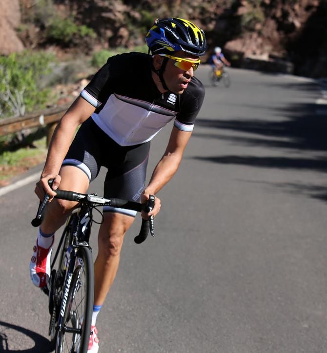 Alberto Contador stands on the pedals on a climb