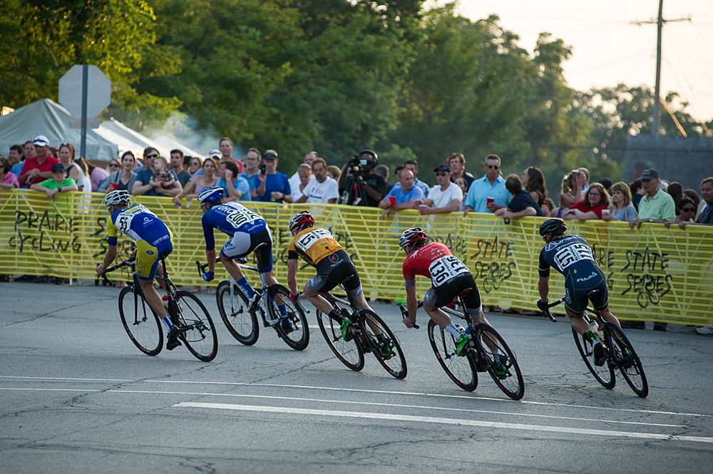 The front of the peloton rounds the last corner