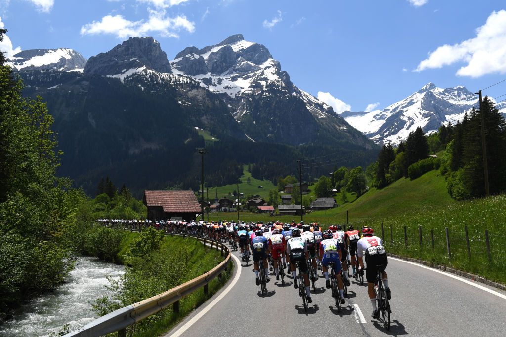 LEUKERBAD SWITZERLAND JUNE 10 Benjamin Thomas of France and Team Groupama FDJ Joel Suter of Switzerland and Team Switzerland The peloton passing through Col du Pillon 1546m mountain landscape during the 84th Tour de Suisse 2021 Stage 5 a 1752km stage from Gstaad to Leukerbad 1385m Mountains Snow UCIworldtour tds tourdesuisse on June 10 2021 in Leukerbad Switzerland Photo by Tim de WaeleGetty Images