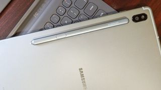Samsung Galaxy Tab S6 flat on a table with its back showing and an S Pen on top of it
