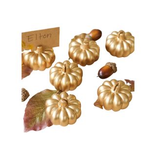 gold Pumpkin Place Card Holders with acorns next to them