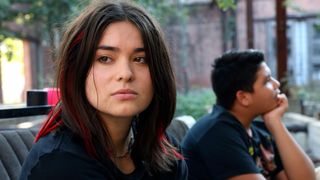 Devery Jacobs as Elora looks contemplatively, while Lane Factor as Cheese looks in the other direction, in Reservation Dogs