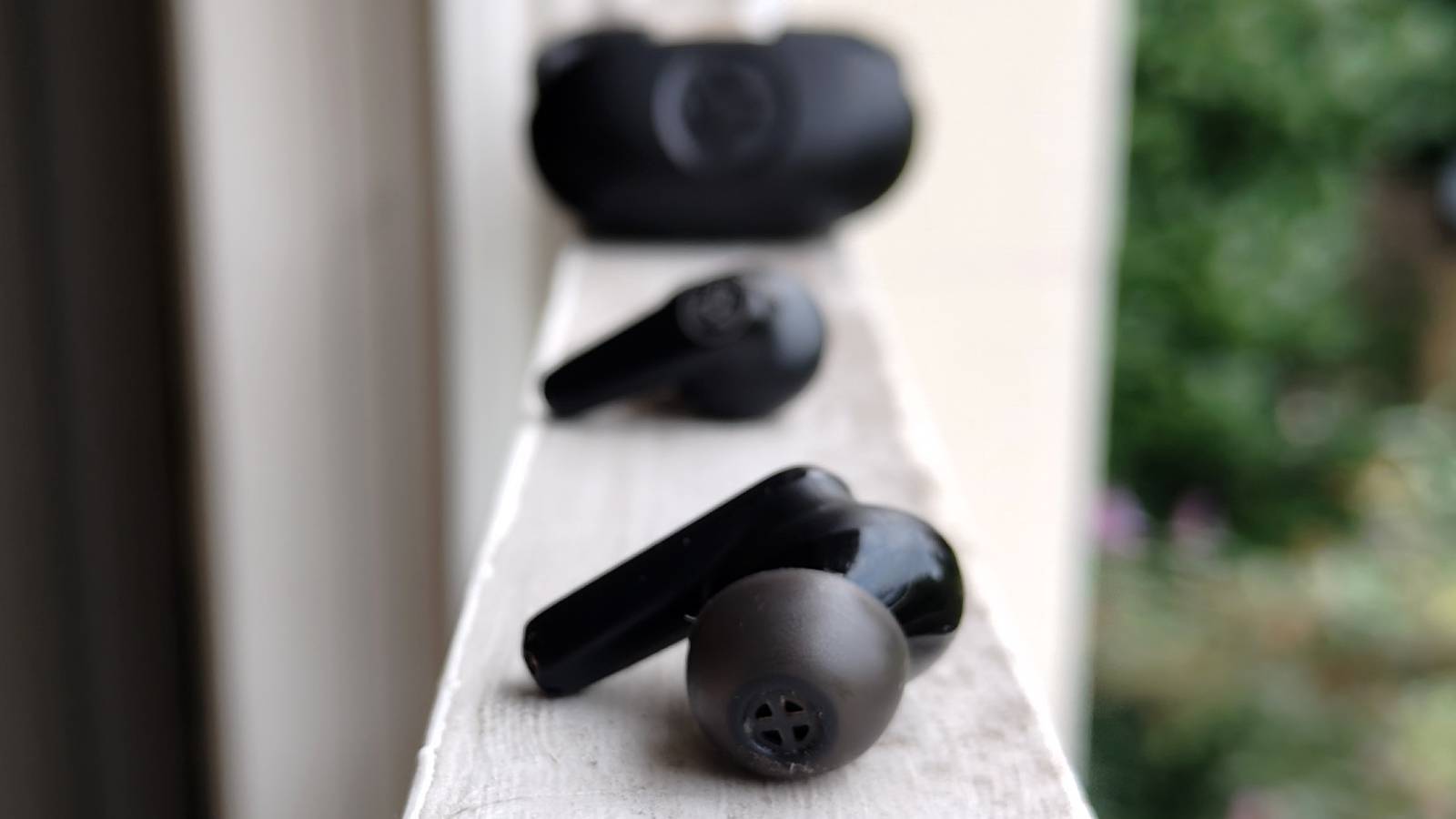 The JLab Go Pods ANC on a window sill.