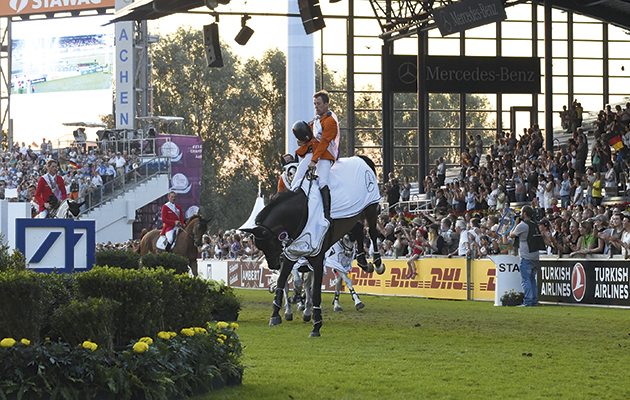 The winning Dutch team on their lap of honour ; Jeroen DUBBELDAM (NED) riding SFN Zenith N.O.P., Maikel VAN DER VLEUTEN (NED) riding VDL Groep Verdi Tn N.O.P., Jur VRIELING (NED) riding VDL Zirocco Blue N.O.P. and Gerco SCHR&amp;Ouml;DER (NED) riding Glock's Cognac Champblanc at the European Team Jumping competition at the FEI European Championships in Aachen, Germany on 21 August 2015