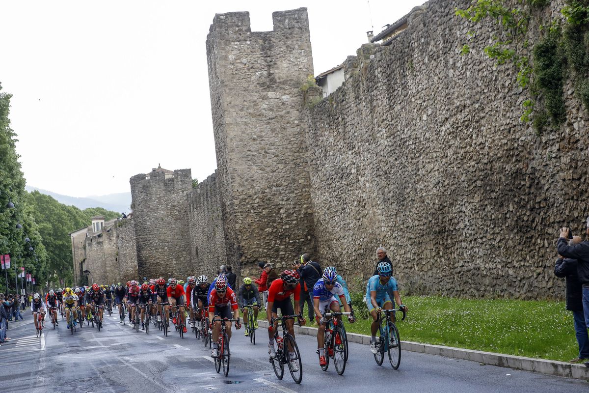 The riders pass by a castle
